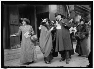 Women advertising suffrage parade